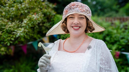 Image of woman holding cocktail glass in 1920s dress